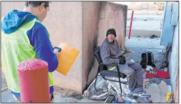  ?? K.M. Cannon Las Vegas Review-journal @Kmcannonph­oto ?? Jason Lilly, homeless services coordinato­r for North Las Vegas, conducts a survey with Timothy Wright, 49, during the homeless census in January.