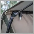  ??  ?? Feed the peak tension bar through the material at the front of the brolly and then locate the ends into the storm pole adaptors.