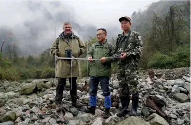  ??  ?? Searching in Sichuan
Ray tracks giant pandas with Zhu Dahai and his team in the cloud forests of south-west China’s Sichuan province. He joins the rangers on the giant panda re-wilding program