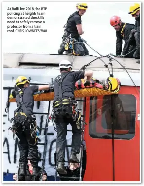  ?? CHRIS LOWNDES/ RAIL. ?? At Rail Live 2018, the BTP policing at heights team demonstrat­ed the skills need to safely remove a protestor from a train roof.