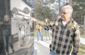  ?? MATT WILLIAMSON/ THE ENTERPRISE- JOURNAL VIA AP PHOTOS ?? Gene Odom, a survivor of the Oct. 20, 1977, plane crash that killed members of the band Lynyrd Skynyrd, points to where he was sitting in the airplane at the Lynyrd Skynyrd monument near the crash site near Gillsburg, Mississipp­i, last week.