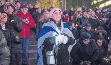  ?? TIJANA MARTIN THE CANADIAN PRESS ?? Annette Hkr-Even joins a large vigil Monday for the shooting in Pittsburgh at Mel Lastman Square in North York.