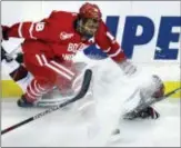  ?? CHARLES KRUPA — THE ASSOCIATED PRESS ?? Boston University’s Jordan Greenway (18) drops Harvard’s Wiley Sherman as they chase the puck in the first round of the Beanpot tournament in Boston on Monday.