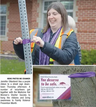  ??  ?? Jennifer Ottenbreit ties a purple ribbon to a street sign downtown Thursday afternoon. A number of volunteers got together with the Medicine Hat Women’s Shelter Society to hang the ribbons and bring awareness to Family Violence Prevention Month. NEWS PHOTOS MO CRANKER