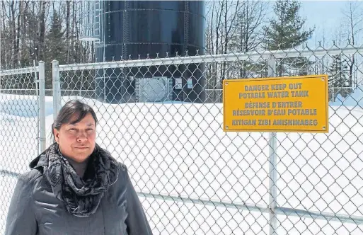  ?? ALEX BALLINGALL/TORONTO STAR ?? Celine Brozeau-Ottawa, near one of the new water storage tanks for the Kitigan Zibi First Nation. Much of the community still doesn’t have safe drinking water.