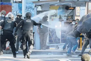  ?? TED S. WARREN/AP 2020 ?? Police use pepper spray on protesters in Seattle during a protest in support of Black Lives Matter.