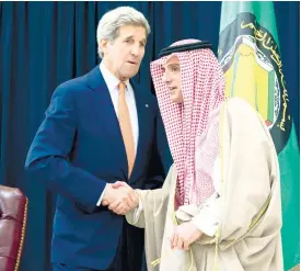  ?? (AP FOTO) ?? U.S. DIPLOMATIC MISSION. US Secretary of State John Kerry (left) and Saudi Foreign Minister Adel al-Jubeir, shake hands after speaking to the media together at King Salman Regional Air Base in Riyadh, Saudi Arabia. Kerry’s Asian trip is expected to...