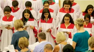  ?? Photos by Ryan Lim ?? Residents attend a mass during the celebratio­n in Abu Dhabi on Wednesday. The church was opened in 1968 and moved to a new building in 1980. —