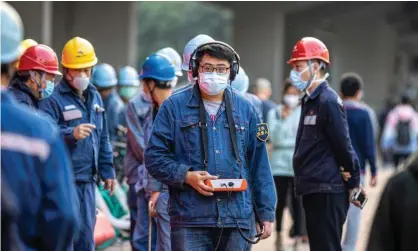  ??  ?? Coronaviru­s outbreak: workers in Guangdong, which is the second worst-hit province. Photograph: Alex Plavevski/EPA