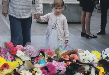  ?? ?? Members of the public lay floral tributes at Oxford Street Mall alongside Westfield Bondi Junction on Sunday. GETTY IMAGES