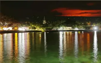  ?? Associated Press photos ?? The glow of the Mauna Loa eruption is seen from Kona Bay on Monday in Kona, Hawaii. Mauna Loa, the world's largest active volcano, erupted Monday for the first time in 38 years.