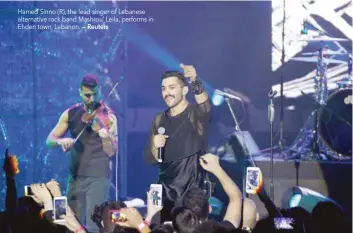  ?? — Reuters ?? Hamed Sinno (R), the lead singer of Lebanese alternativ­e rock band Mashrou’ Leila, performs in Ehden town, Lebanon.