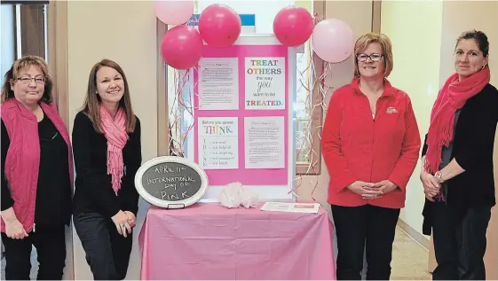  ?? SPECIAL TO THE EXAMINER ?? The staff at the Norwood Royal Bank were pretty in pink in recognitio­n of the anit-bully initiative Day of Pink on April 11. Staff also decorated the downtown businesses with pink balloons for the day. From left are staff members Kim Patterson, Heather...