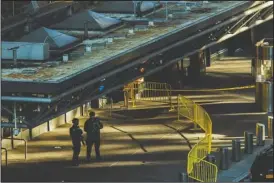  ?? The Associated Press ?? NEW YORK BOMBING: Police stand guard in front of Port Authority Bus Terminal following an explosion Monday near New York’s Times Square. Police said a man with a pipe bomb strapped to him set off the crude device in an undergroun­d passageway under 42nd Street between Seventh and Eighth avenues.