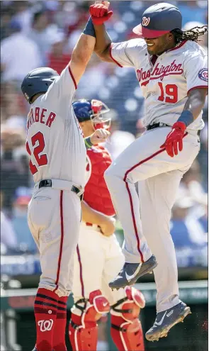  ?? LAURENCE KESTERSON — THE ASSOCIATED PRESS ?? The Washington Nationals’ Josh Bell (19) celebrates with Kyle Schwarber (12) after hitting a grand slam home run during the sixth inning of a baseball game against the Philadelph­ia Phillies, Wednesday, in Philadelph­ia. The Phillies surrendere­d the lead three times and ultimately fell to the Nationals 13-12in a two-game sweep.