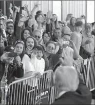  ?? NWA Democrat-Gazette/BEN GOFF ?? Donald Trump greets the crowd Saturday after his appearance at Northwest Arkansas Regional Airport. Some people abandoned their cars in thick traffic and walked as far as 2 miles to get there, officials said.