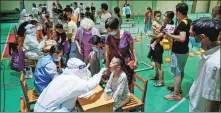  ?? LI BO / XINHUA ?? Health workers collect nucleic acid test samples at a testing center in Nanjing’s Jianye district, Jiangsu province, on Wednesday.