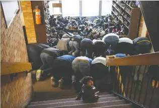  ??  ?? March 22
Members of the congregati­on at the IAOS Regina Mosque on Montague Street pray, some resorting to finding
space in the hallways and foyer, as the prayer room was full.