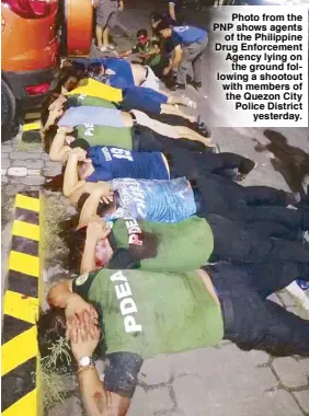  ??  ?? Photo from the PNP shows agents of the Philippine Drug Enforcemen­t Agency lying on the ground following a shootout with members of the Quezon City Police District yesterday.