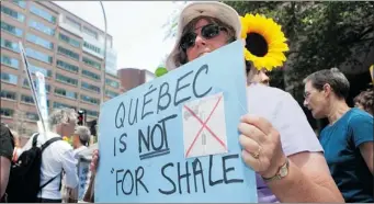  ?? DARIO AYALA/ GAZETTE FILE PHOTO ?? It took more than a year after her protest, but the woman’s sign turned out Thursday to be correct as Pauline Marois’s government rejected plans to develop the shale gas industry in Quebec.