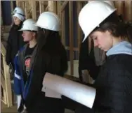  ??  ?? Kennett students read plans for townhomes during a tour of a constructi­on site in Kennett Square recently.