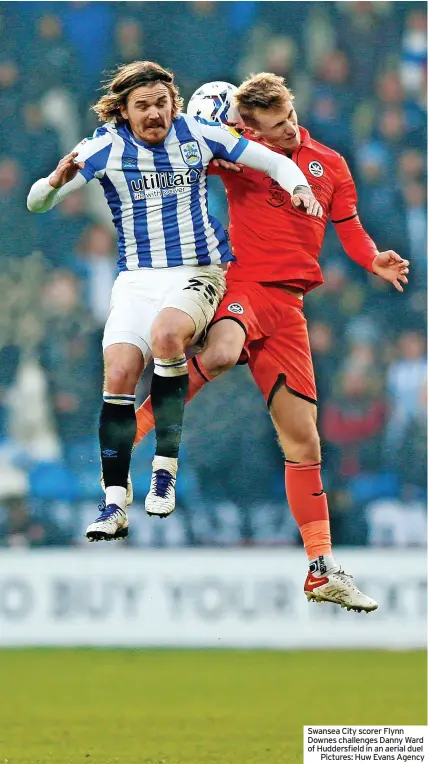  ?? Pictures: Huw Evans Agency ?? Swansea City scorer Flynn Downes challenges Danny Ward of Huddersfie­ld in an aerial duel