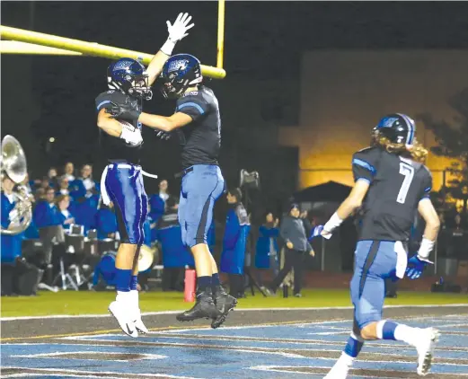  ?? ALLEN CUNNINGHAM/FOR THE SUN-TIMES ?? Matt Judd (left) and Jackson Ritter celebrate after Judd’s touchdown reception as Lincoln-Way East cruised past Homewood-Flossmoor.