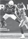  ?? ROB SCHUMACHER/THE REPUBLIC ?? Cardinals strong safety Budda Baker intercepts a pass in front of Seahawks running back Chris Carson Sunday.