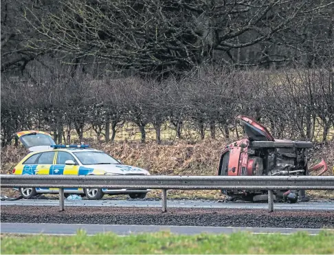  ??  ?? FAILED TO STOP: The Vauxhall Corsa crashed on the A90 near St Madoes following a police chase. Picture by Mhairi Edwards.