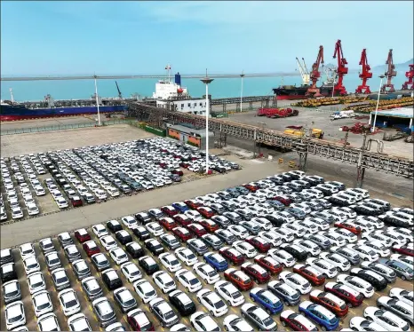  ?? WANG CHUN / FOR CHINA DAILY ?? Export-bound vehicles await loading at Lianyungan­g Port, Jiangsu province.
Erik Berglof,