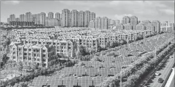  ?? ?? Solar panels stand beside a residentia­l area in Sino-Singapore Tianjin Eco-City in June. All of the ecocity’s buildings are green structures, employing technologi­es for natural ventilatio­n, natural lighting and renewable energy systems, according to its developer.