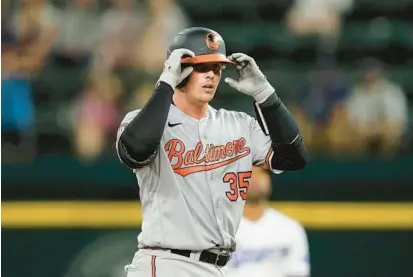  ?? TONY GUTIERREZ/AP ?? Cedric Mullins smacked a home run to open the game, quickly flushing away the emotional carryover from trading Trey Mancini earlier in the day, and Adley Rutschman, above, had three hits, including two doubles, in the Orioles’ 7-2 win over the Texas Rangers on Monday.