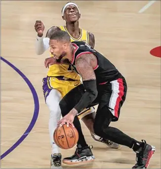  ?? Robert Gauthier Los Angeles Times ?? THE LAKERS’ Dennis Schroder is called for a foul while defending Portland’s Damian Lillard.