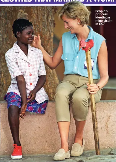  ??  ?? People’s princess: Meeting a mine victim in 1997