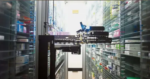  ??  ?? Advanced technology: A robot retrieving medicines in the pharmacy of a hospital in France. Recent advances have heightened concerns on automation replacing a growing number of occupation­s, including highly skilled jobs. — AFP