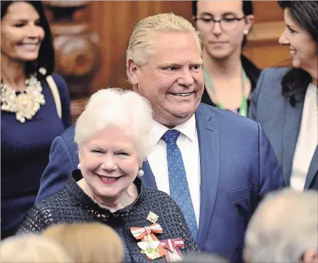  ?? FRANK GUNN THE CANADIAN PRESS ?? Lt.-Gov. Elizabeth Dowdeswell and Premier Doug Ford arrive ahead of the speech from the throne to open the new legislativ­e session on Thursday.