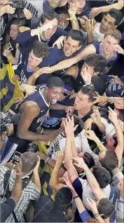  ?? Michael Simmons Associated Press ?? EVERYBODY LOVED Kris Jenkins after his buzzerbeat­ing three-pointer gave Villanova a thrilling win over North Carolina in NCAA basketball title game.