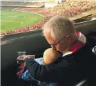  ??  ?? Turnbull holds his baby granddaugh­ter Alice during a football match in Sydney.