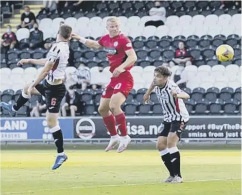 ??  ?? St Mirren striker Curtis Main leaps between Dunfermlin­e duo Kyle Macdonald and Aaron Comrie to score the only goal of the game