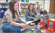  ?? OKLAHOMAN] ?? Ashley Hill, right, with her daughter Eveie Ortiz, 2, and son Natalio Ortiz, 2 months, participat­es in the Right Track program with parent educator Amber Hidalgo at the Parent Promise office in Oklahoma City. The program helps moms like Hill adjust to the challenges of bringing a new baby home. [CHRIS LANDSBERGE­R/ THE