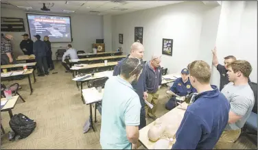  ?? (NWA Democrat-Gazette/Ben Goff) ?? Firefighte­r/paramedics from Rogers and Fort Smith train for cardiac emergencie­s Thursday in one of the classrooms at the Rogers Fire Department Training Center.