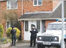  ?? AP PHOTO ?? Police officers stand outside the house of former Russian double agent Sergei Skripal, who was found critically ill Sunday following exposure to an “unknown substance” in Salisbury, England.