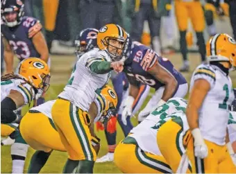  ?? AP FILE PHOTO/NAM Y. HUH ?? Green Bay Packers quarterbac­k Aaron Rodgers, center, set a franchise record with 48 touchdown passes during the regular season to help lead the team to the NFC’s No. 1 seed and a 13-3 record.