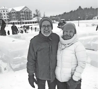  ?? MARBONE/ADIRONDACK DAILY ENTERPRISE AARON ?? Gretchen Koehler and her husband Joel Foisy stand at the Ice Palace build site on Tuesday. Koehler is composing a fiddle song about ice harvesting and traveled from Potsdam to see it happen in person.