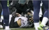  ?? TED S. WARREN — THE ASSOCIATED PRESS ?? Eagles tight end Zach Ertz is tended to after banging his head into the turf during the second half Sunday against the Seahawks.