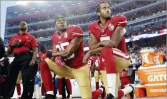  ?? MARCIO JOSE SANCHEZ — THE ASSOCIATED PRESS FILE ?? In this file photo, San Francisco 49ers safety Eric Reid (35) and quarterbac­k Colin Kaepernick (7) kneel during the national anthem before a game against the Los Angeles Rams in Santa Clara. NFL owners have approved a new policy aimed at addressing the...