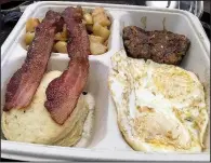  ?? Arkansas Democrat-Gazette/ERIC E. HARRISON ?? The to-go Blue Collar Breakfast at Cathead’s Diner — (clockwise from top left) two strips of bacon, potato hash, a breakfast sausage patty, two fried eggs (over medium) and the restaurant’s signature cathead biscuit — came in a fiberboard container.