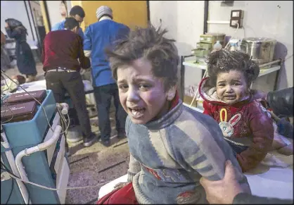  ?? EPA ?? Injured children are treated at a hospital in rebel-held Douma in Syria on Monday. At least 100 people were killed in heavy bombing by forces allegedly loyal to the Syrian government.