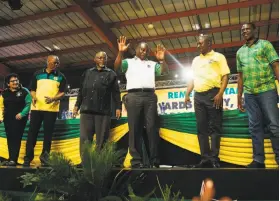  ?? Waldo Swiegers / Bloomberg News ?? Cyril Ramaphosa (center) greets delegates at the African National Congress party conference in Johannesbu­rg. He hopes to revitalize the economy.