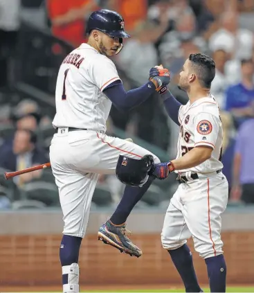  ?? Karen Warren / Houston Chronicle ?? Teammate Carlos Correa, left, almost seems happier about Jose Altuve’s game-tying home run in the fourth inning than the second baseman, who also Tuesday was named winner of the Lou Gehrig Memorial Award.